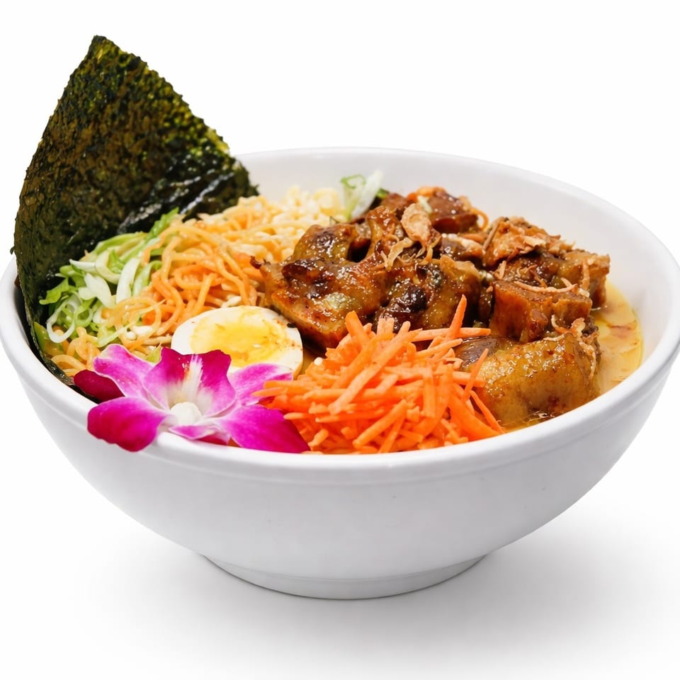 Bowl of glazed meat with shredded carrots, cabbage, noodles, egg, seaweed, and an orchid garnish.